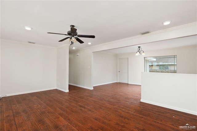 spare room featuring baseboards, hardwood / wood-style floors, and crown molding