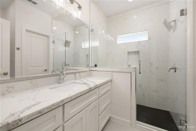 bathroom featuring vanity and a shower with shower door