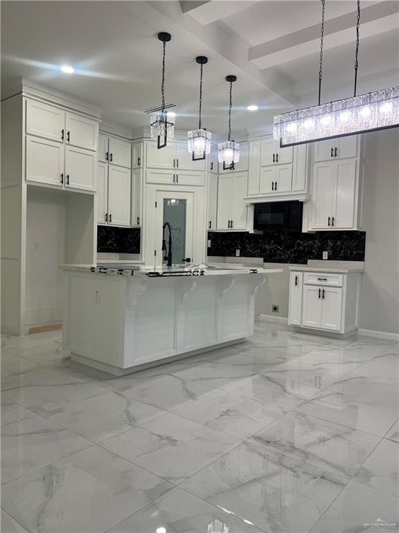 kitchen featuring pendant lighting, decorative backsplash, a center island, and white cabinets