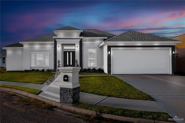 503 Purple Bugambilia, Pharr, TX 78577 - prairie-style house featuring a garage, driveway, a lawn, a shingled roof, and stucco siding