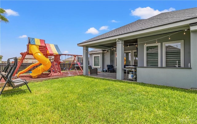 view of yard with a playground and a patio area