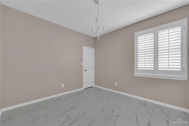 3902 Green Jay Dr, Mission, TX 78572 - unfurnished room featuring marble look tile flooring, a chandelier, and baseboards