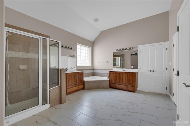 3902 Green Jay Dr, Mission, TX 78572 - full bathroom with two vanities, a stall shower, vaulted ceiling, a bath, and marble finish floors