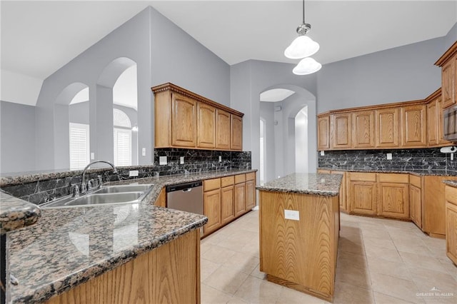 3902 Green Jay Dr, Mission, TX 78572 - kitchen featuring stainless steel appliances, a sink, dark stone countertops, tasteful backsplash, and hanging light fixtures