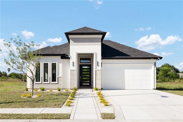 view of front of property with a front lawn and a garage