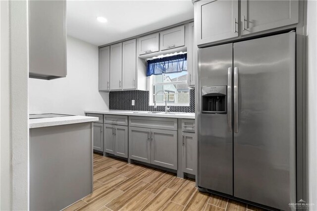 403 N 1st St, Donna, TX 78537 - kitchen featuring stainless steel refrigerator with ice dispenser, gray cabinetry, a sink, light countertops, and recessed lighting