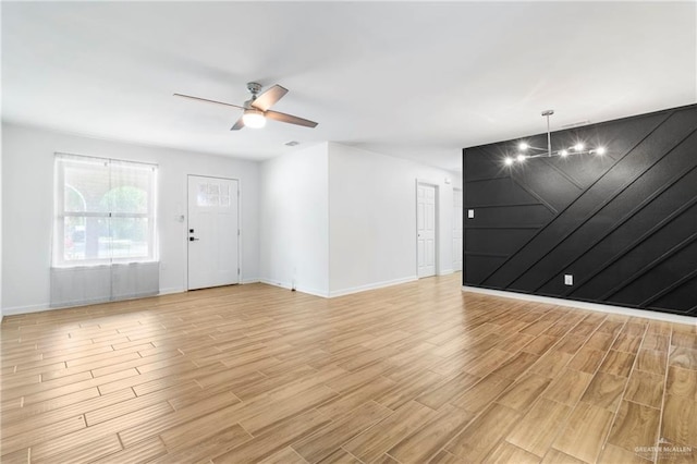 403 N 1st St, Donna, TX 78537 - unfurnished living room featuring ceiling fan, light wood-style floors, and baseboards
