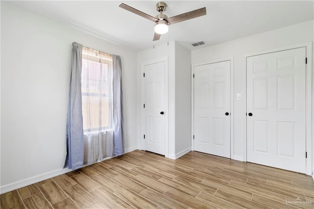 403 N 1st St, Donna, TX 78537 - unfurnished bedroom with light wood-style flooring, baseboards, and ceiling fan