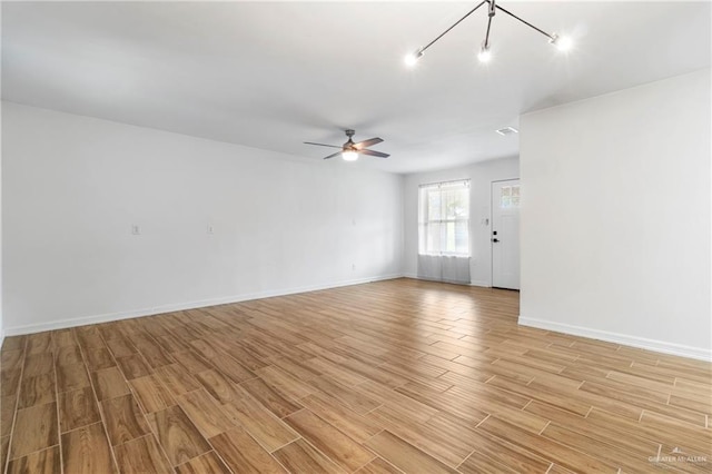 403 N 1st St, Donna, TX 78537 - unfurnished room with light wood-type flooring, a ceiling fan, and baseboards