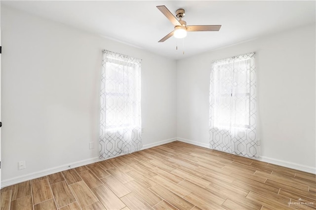 403 N 1st St, Donna, TX 78537 - unfurnished room with wood finish floors, a ceiling fan, and baseboards