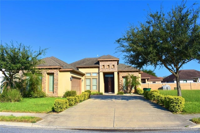 view of front of home with a garage and a front yard