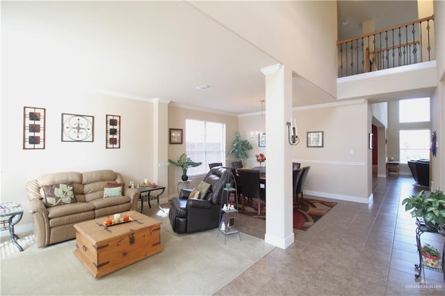 tiled living room featuring crown molding and a chandelier