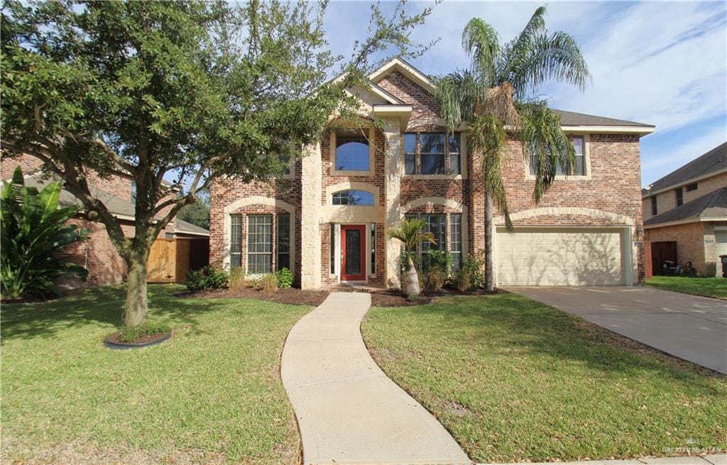 view of front of property with a garage and a front lawn