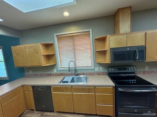 kitchen with sink, black appliances, and light brown cabinets