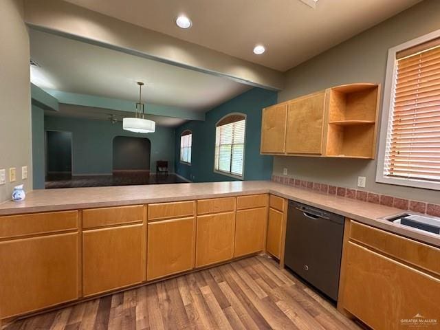 kitchen featuring dishwasher, hanging light fixtures, beam ceiling, light hardwood / wood-style floors, and kitchen peninsula