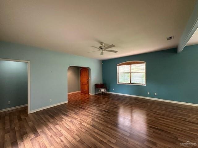 spare room with dark wood-type flooring and ceiling fan