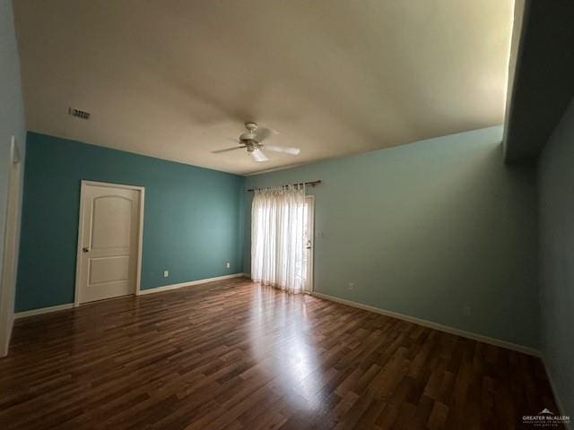 empty room featuring ceiling fan and dark hardwood / wood-style flooring