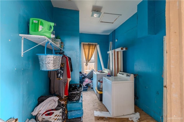 clothes washing area with washing machine and dryer