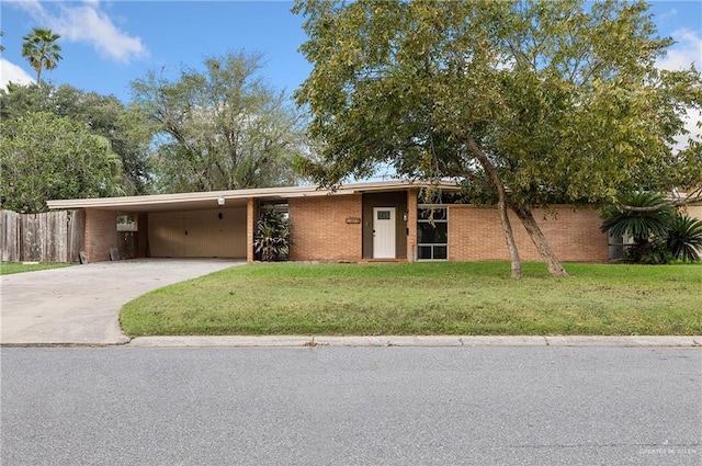 ranch-style house featuring a carport and a front yard