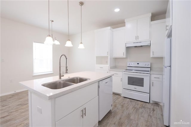 kitchen with sink, white cabinetry, hanging light fixtures, a center island with sink, and white appliances