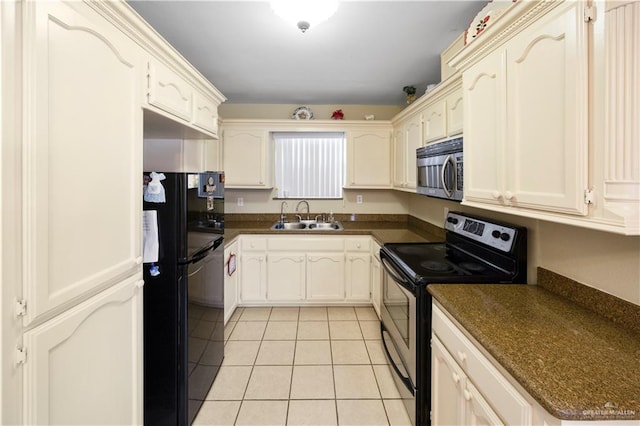 kitchen featuring sink, light tile patterned floors, and black appliances