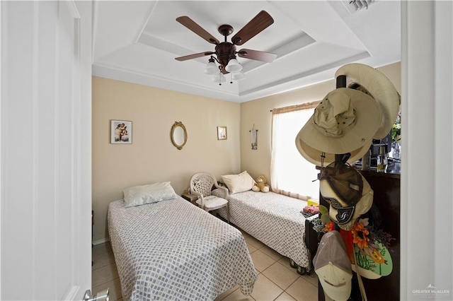 bedroom featuring a raised ceiling, ceiling fan, and light tile patterned floors