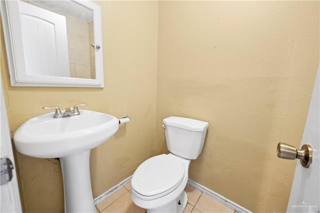 bathroom featuring tile patterned floors and toilet