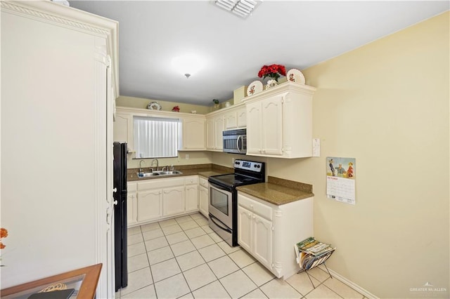 kitchen featuring sink, white cabinetry, and stainless steel appliances