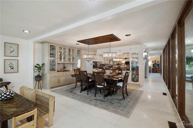 dining room with an inviting chandelier and light tile patterned floors