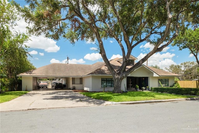 ranch-style home with a front yard and a carport