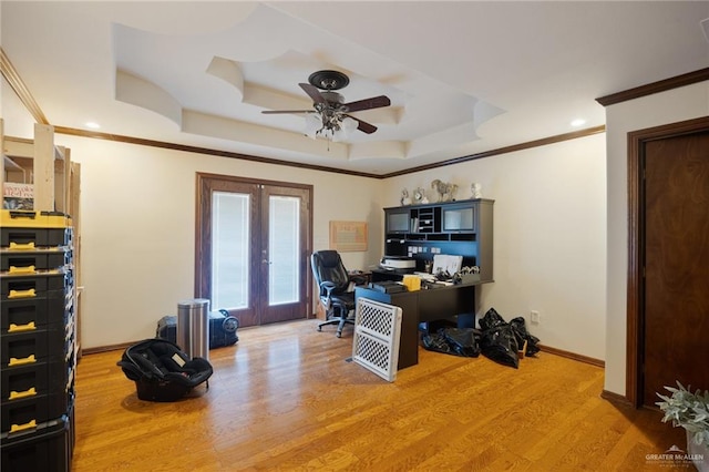 office with crown molding, a tray ceiling, wood-type flooring, and french doors