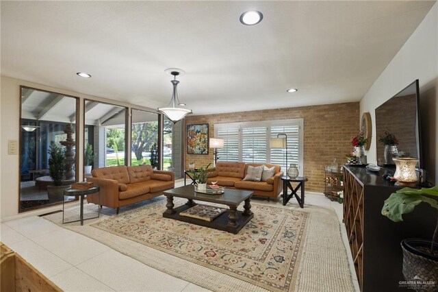 living room with brick wall and light tile patterned floors