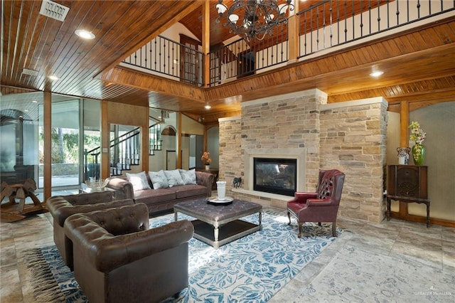 living room with an inviting chandelier, high vaulted ceiling, wooden ceiling, and a large fireplace