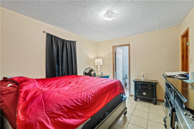 tiled bedroom featuring connected bathroom and a textured ceiling