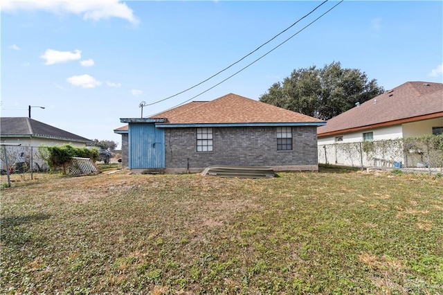 rear view of house with a lawn