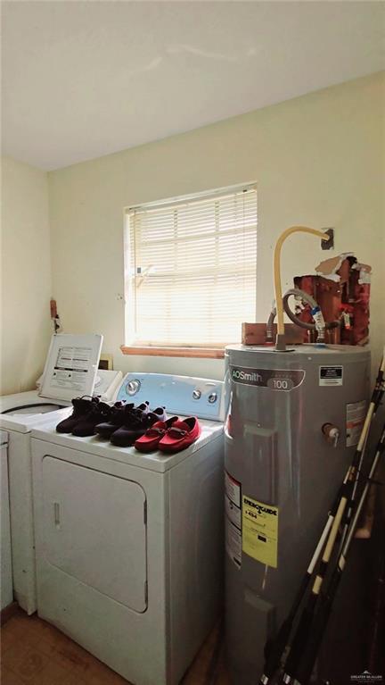 laundry area featuring separate washer and dryer and electric water heater