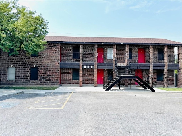 1411 Oak St, Weslaco, TX 78596 - view of property with uncovered parking and stairway
