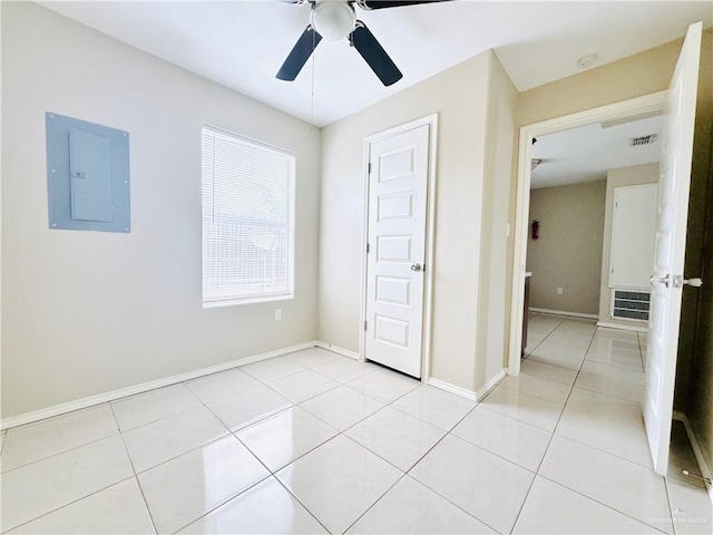 1411 Oak St, Weslaco, TX 78596 - unfurnished bedroom featuring electric panel, a ceiling fan, baseboards, and light tile patterned floors