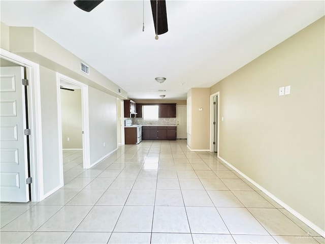 1411 Oak St, Weslaco, TX 78596 - unfurnished living room featuring ceiling fan, baseboards, light tile patterned flooring, and visible vents