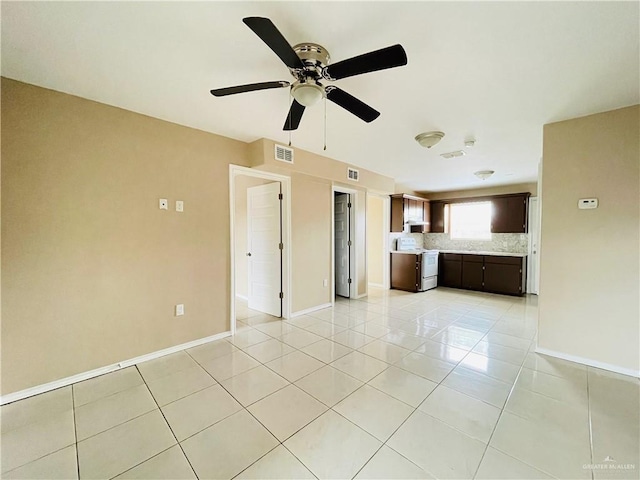 1411 Oak St, Weslaco, TX 78596 - unfurnished living room featuring baseboards, a ceiling fan, visible vents, and light tile patterned floors