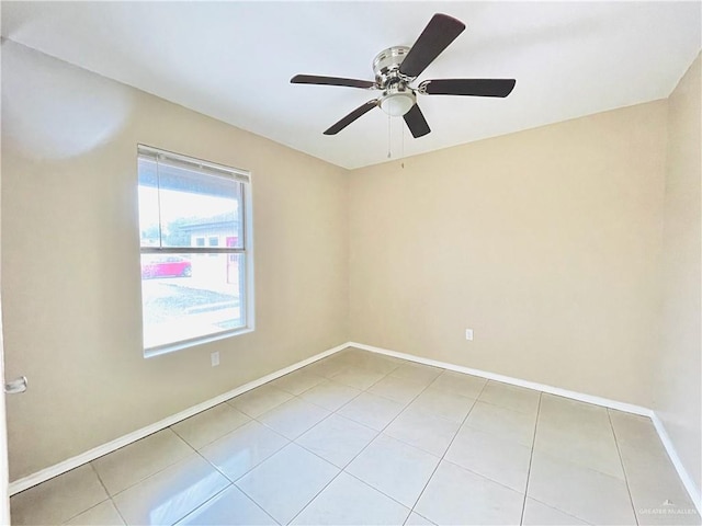 1411 Oak St, Weslaco, TX 78596 - tiled empty room with baseboards and ceiling fan