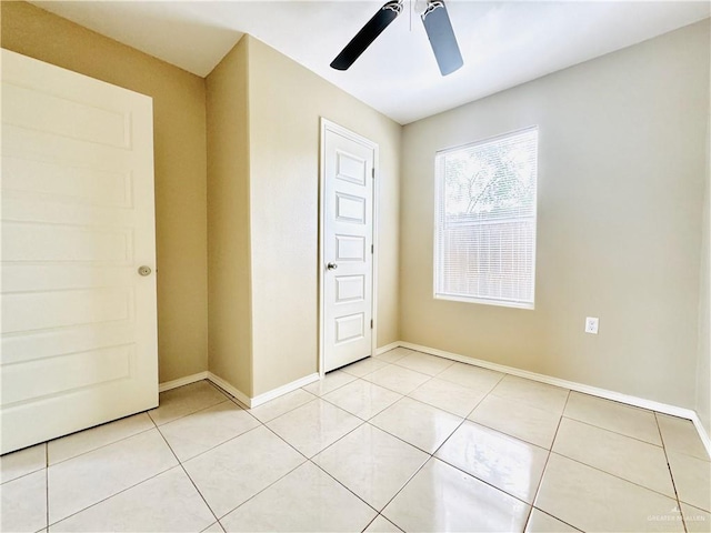 1411 Oak St, Weslaco, TX 78596 - spare room with light tile patterned floors, baseboards, and ceiling fan
