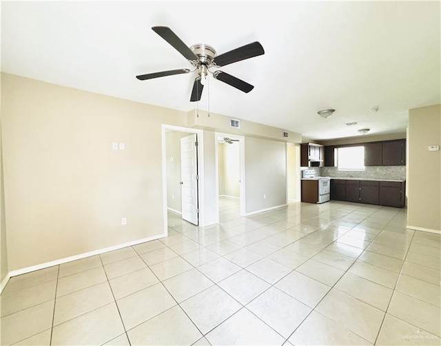 1411 Oak St, Weslaco, TX 78596 - unfurnished living room featuring baseboards, a ceiling fan, visible vents, and light tile patterned floors