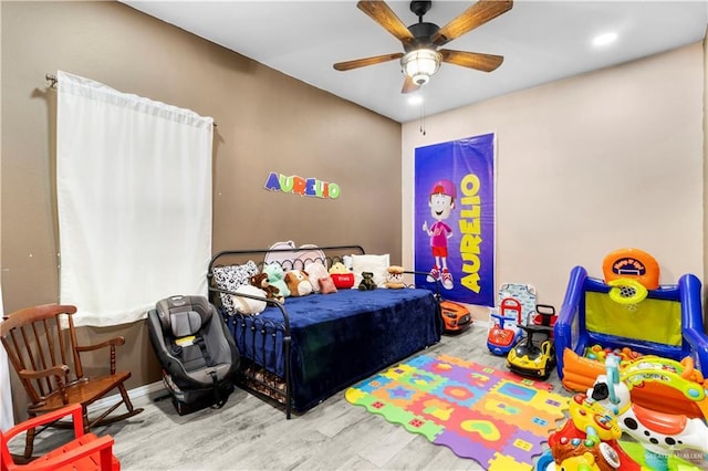 bedroom featuring baseboards, ceiling fan, and wood finished floors