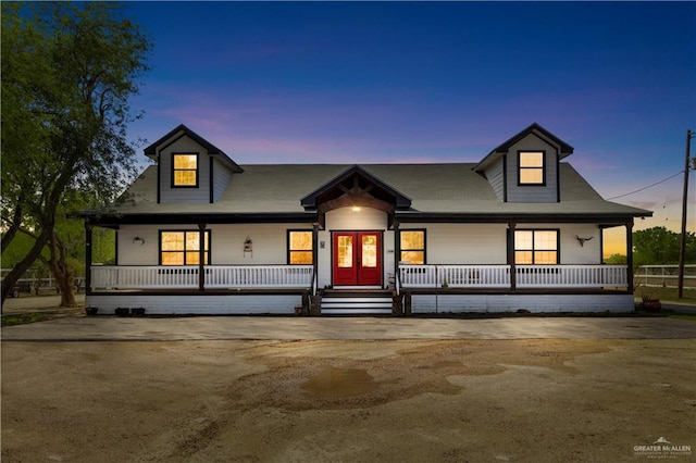 view of front of house featuring covered porch and french doors