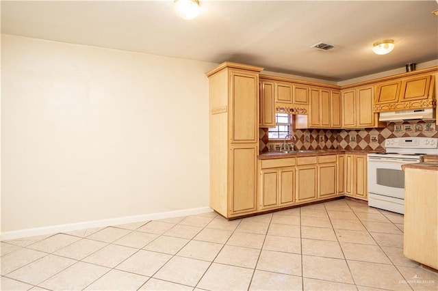 kitchen featuring light brown cabinetry, sink, backsplash, light tile patterned floors, and electric stove