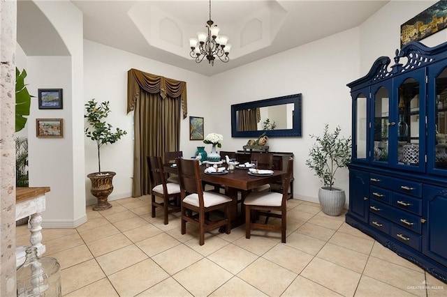 806 Beryl Cir, Weslaco, TX 78596 - dining room with light tile patterned floors, a chandelier, arched walkways, and baseboards