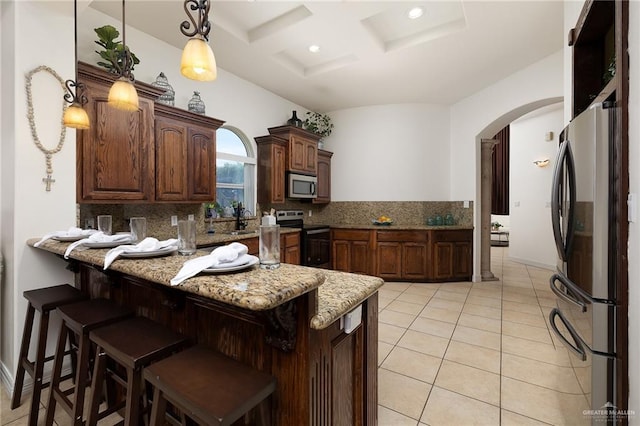 806 Beryl Cir, Weslaco, TX 78596 - kitchen featuring stainless steel appliances, arched walkways, a peninsula, decorative backsplash, and coffered ceiling