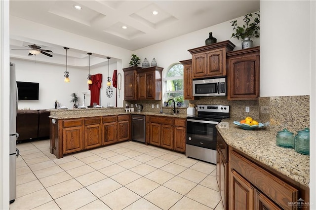 806 Beryl Cir, Weslaco, TX 78596 - kitchen featuring appliances with stainless steel finishes, a sink, coffered ceiling, tasteful backsplash, and a peninsula