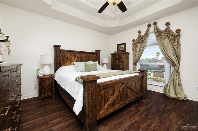 806 Beryl Cir, Weslaco, TX 78596 - bedroom featuring a tray ceiling, wood finished floors, access to outside, baseboards, and ceiling fan